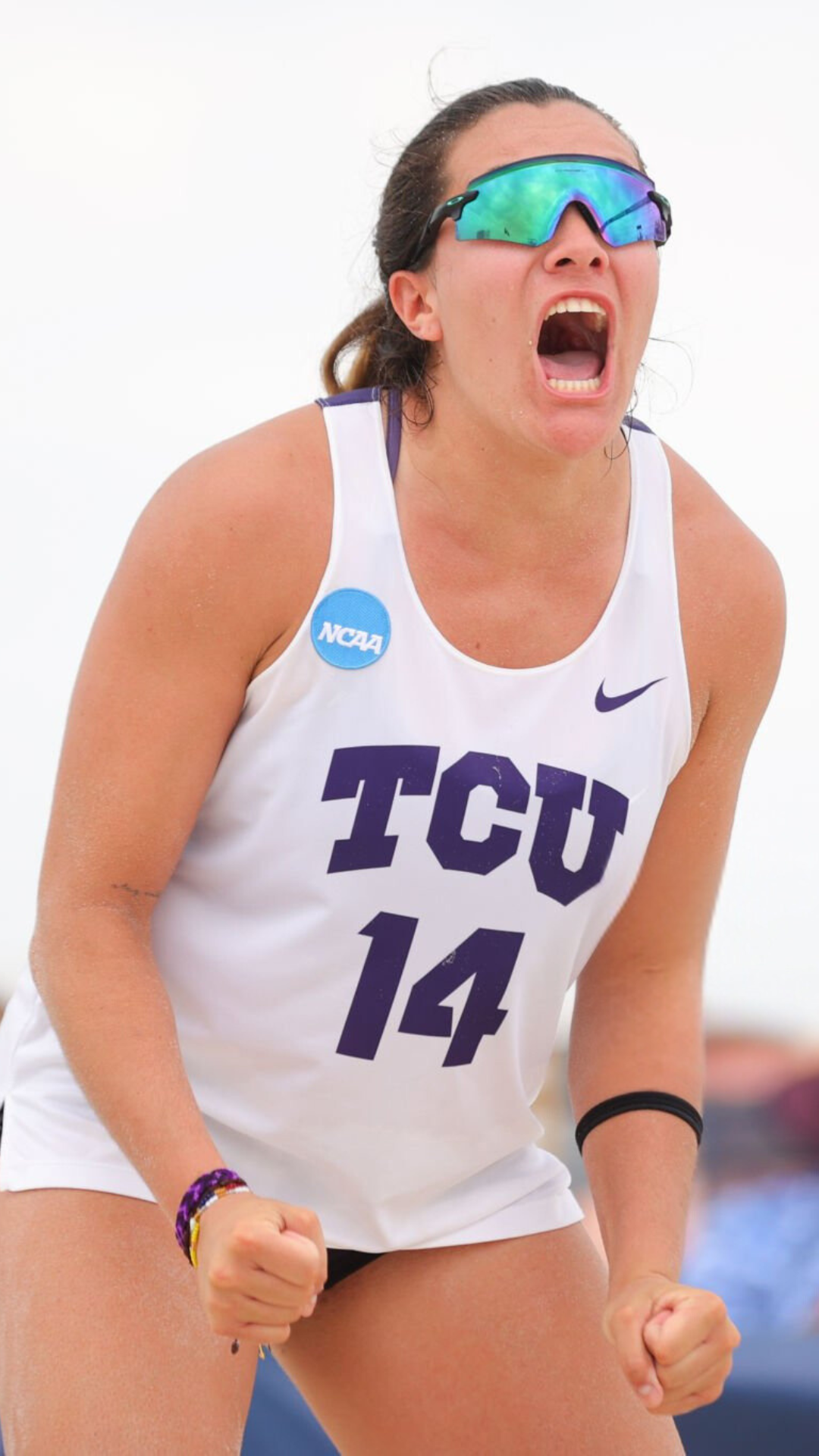 TCU-celebrating-victory-LSU-UCLA-commit-NCAA-d1-championship-recruiting-salavavolleyball-advisory-college-beachvolleyball-scholarship A Texas TCU Horned Frog athlete celebrates success in college beach volleyball. Salava Volleyball: Your trusted advisor for navigating the college recruiting process.
